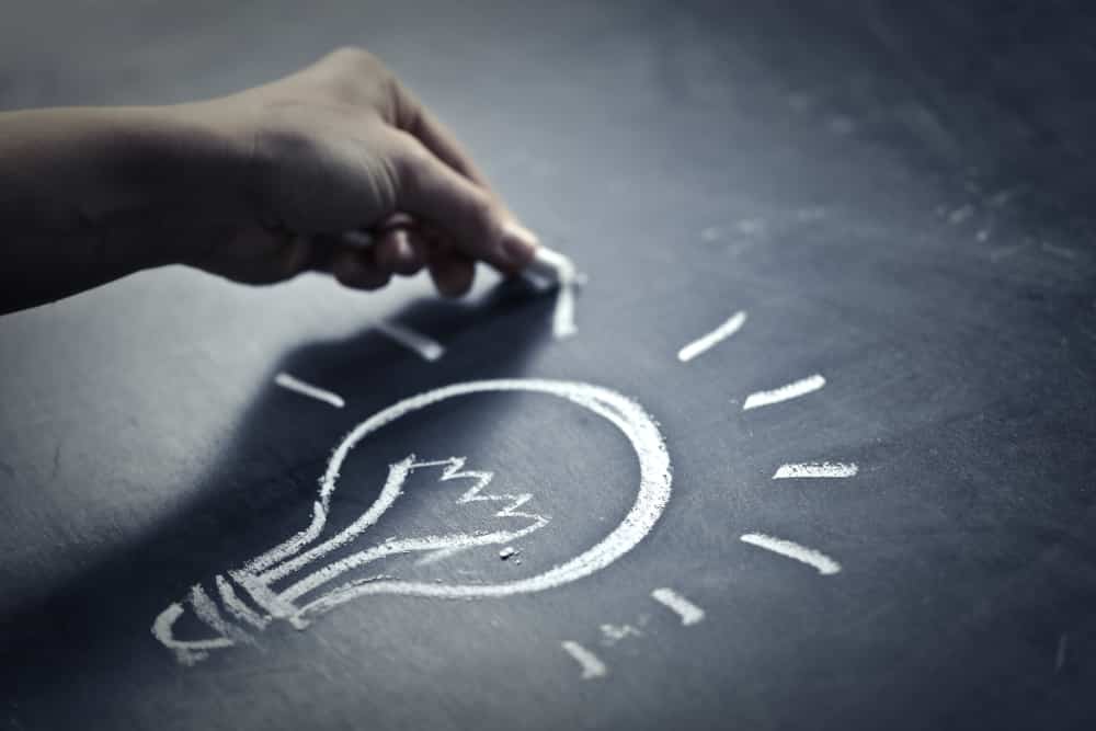 drawing a lightbulb on a chalkboard